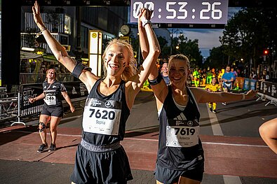 Frauen laufen freudestrahlend und händchenhaltend durch das Ziel © SCC EVENTS | camera 4