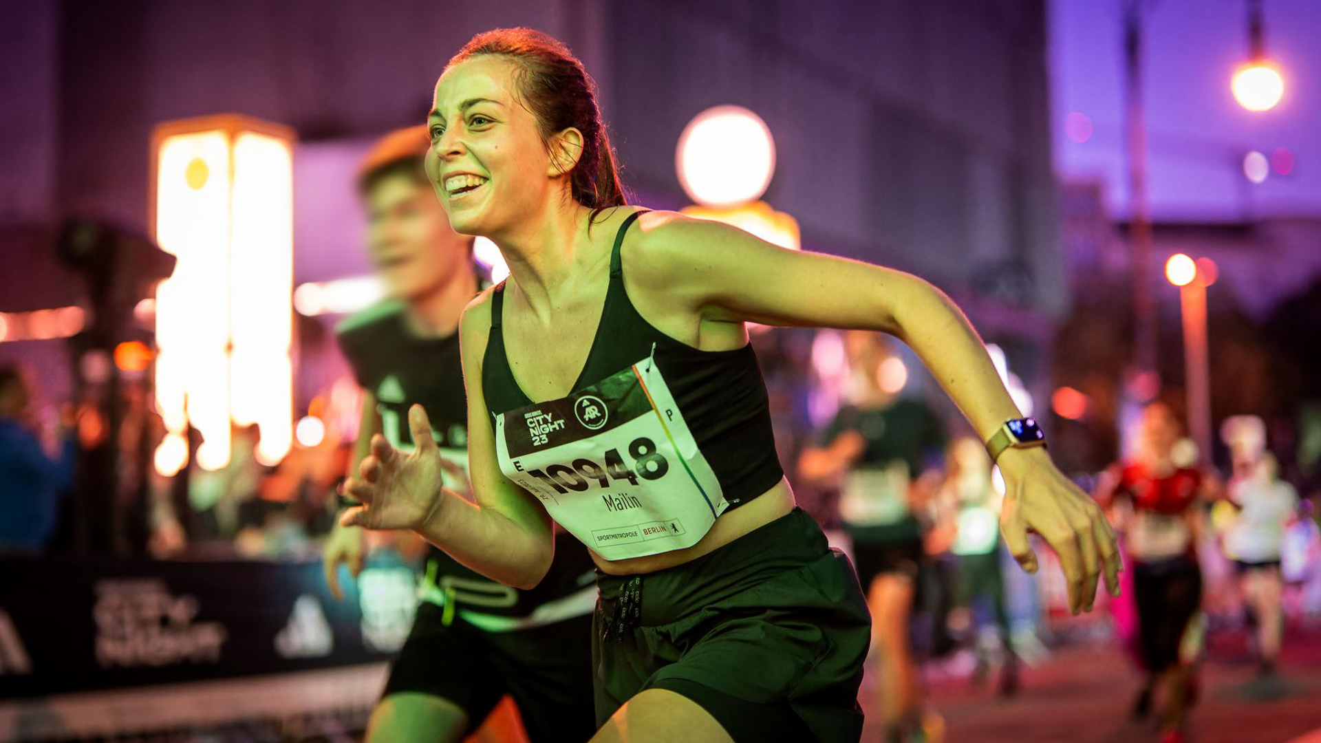 Woman runs happy to the finish line